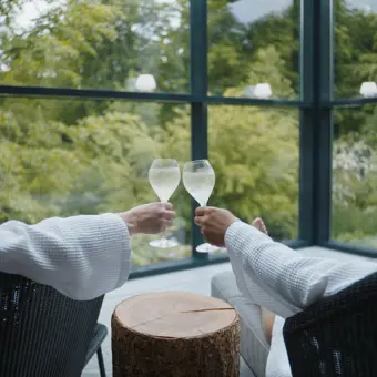 Mand og kvinde skåler i champagne i spaen